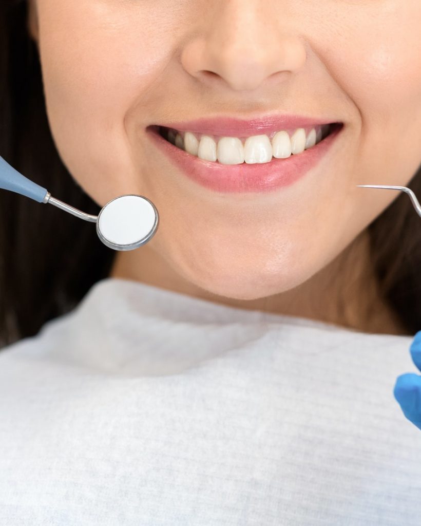 Close up of smiling woman attenting dental clinic